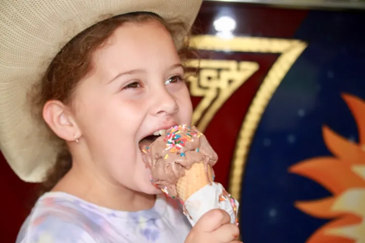 a little girl that is eating some food