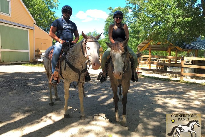 a man riding a horse on a dirt road